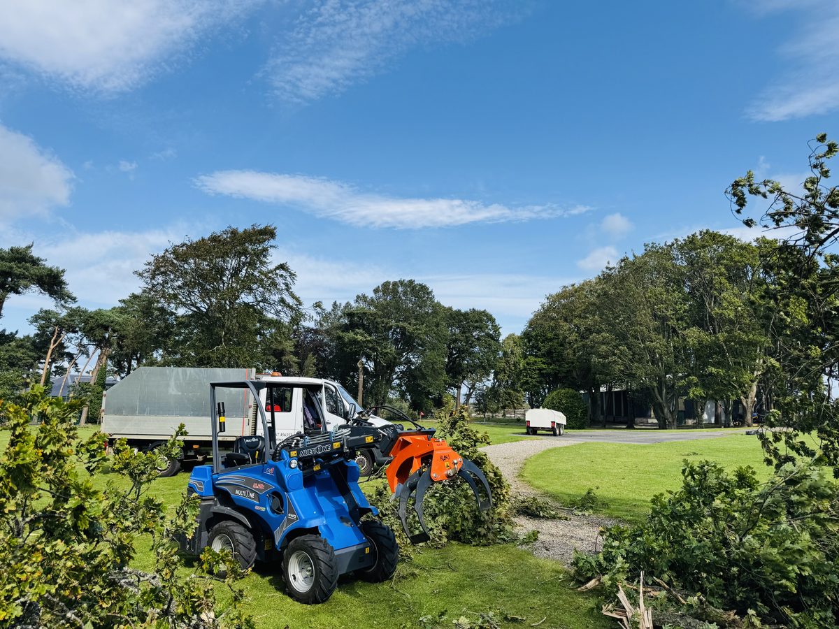 Multi One mini-loader carrying brash on a clear blue Highland day